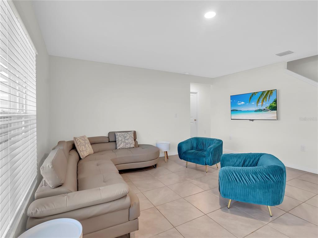 5446 Logan Cave Avenue Wimauma, FL 33598 - Photo 21 of 57 a living room with furniture and a window