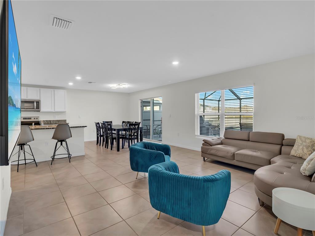 5446 Logan Cave Avenue Wimauma, FL 33598 - Photo 22 of 57 a living room with furniture and a large window