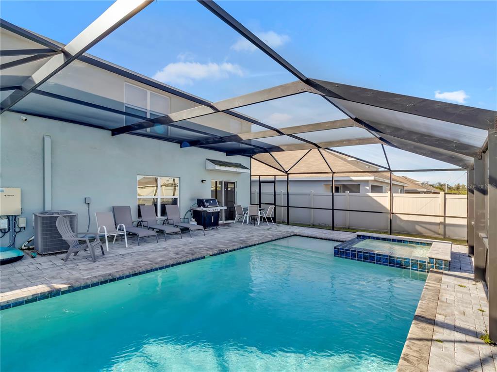 5446 Logan Cave Avenue Wimauma, FL 33598 - Photo 28 of 57 a view of a backyard with sitting area