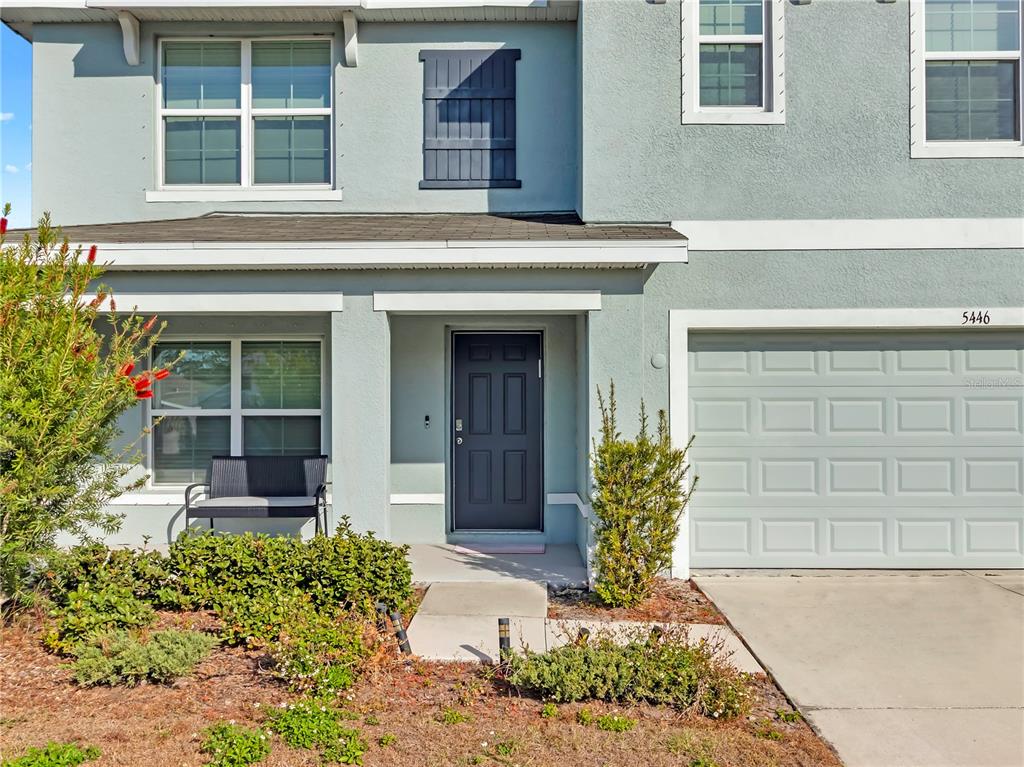 5446 Logan Cave Avenue Wimauma, FL 33598 - Photo 3 of 57 a front view of a house with garden