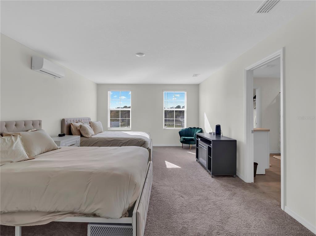 5446 Logan Cave Avenue Wimauma, FL 33598 - Photo 31 of 57 a bed room with a bed and furniture