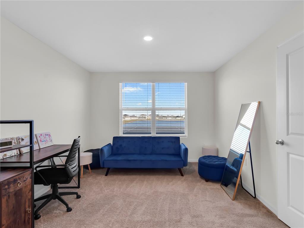 5446 Logan Cave Avenue Wimauma, FL 33598 - Photo 38 of 57 a living room with furniture and a window