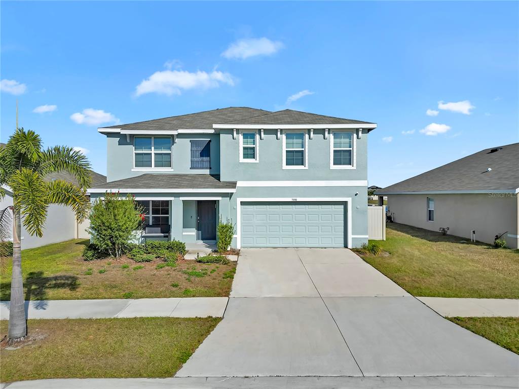 5446 Logan Cave Avenue Wimauma, FL 33598 - Photo 43 of 57 a front view of a house with a yard and garage
