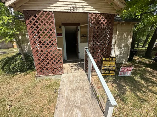 a room with a window wooden floor and a sink