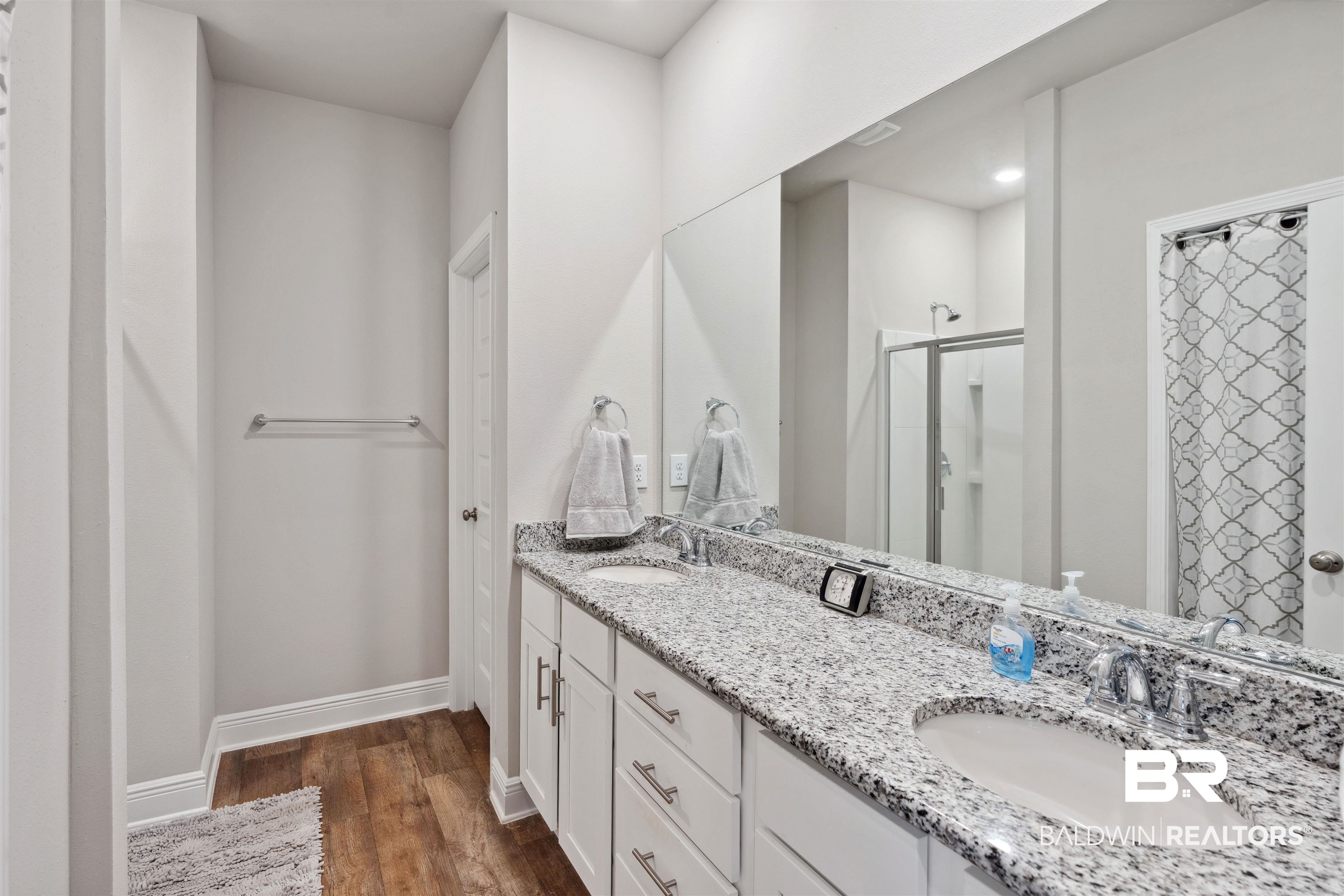 23809 Devonfield Lane Daphne, AL 36526 - Photo 18 of 29 Bathroom with baseboards, a sink, a stall shower, and wood finished floors