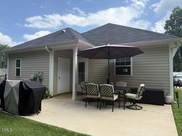 574 East Ridge Avenue Liberty, NC 27298 - Photo 4 of 28 a view of a patio with a table and chairs under an umbrella