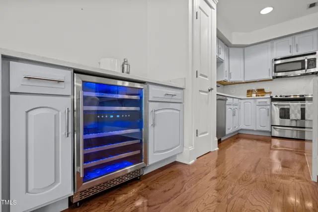 a kitchen with stainless steel appliances granite countertop a refrigerator and a stove