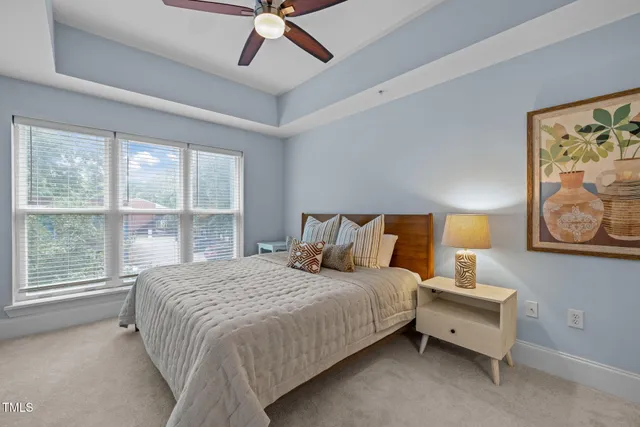 a bedroom with a bed and a large window