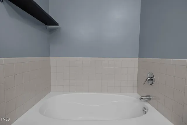 a white bath tub sitting in a bathroom