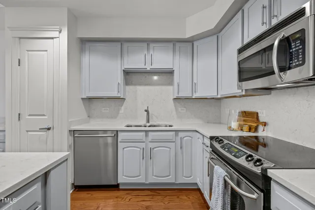 a kitchen with stainless steel appliances granite countertop a stove a microwave and cabinets