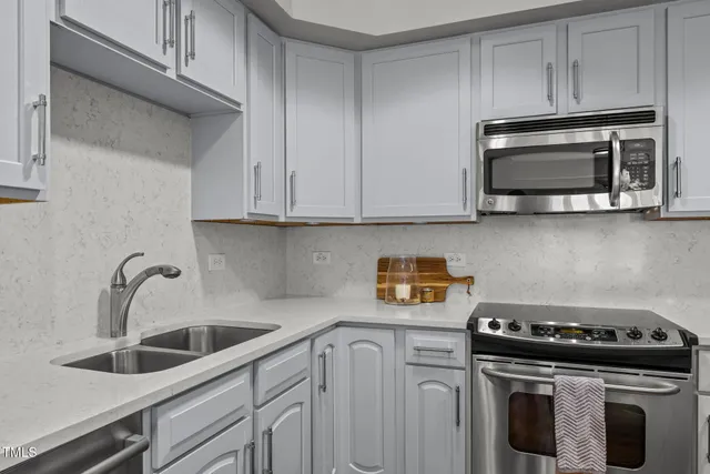 a kitchen with stainless steel appliances a stove a microwave and cabinets