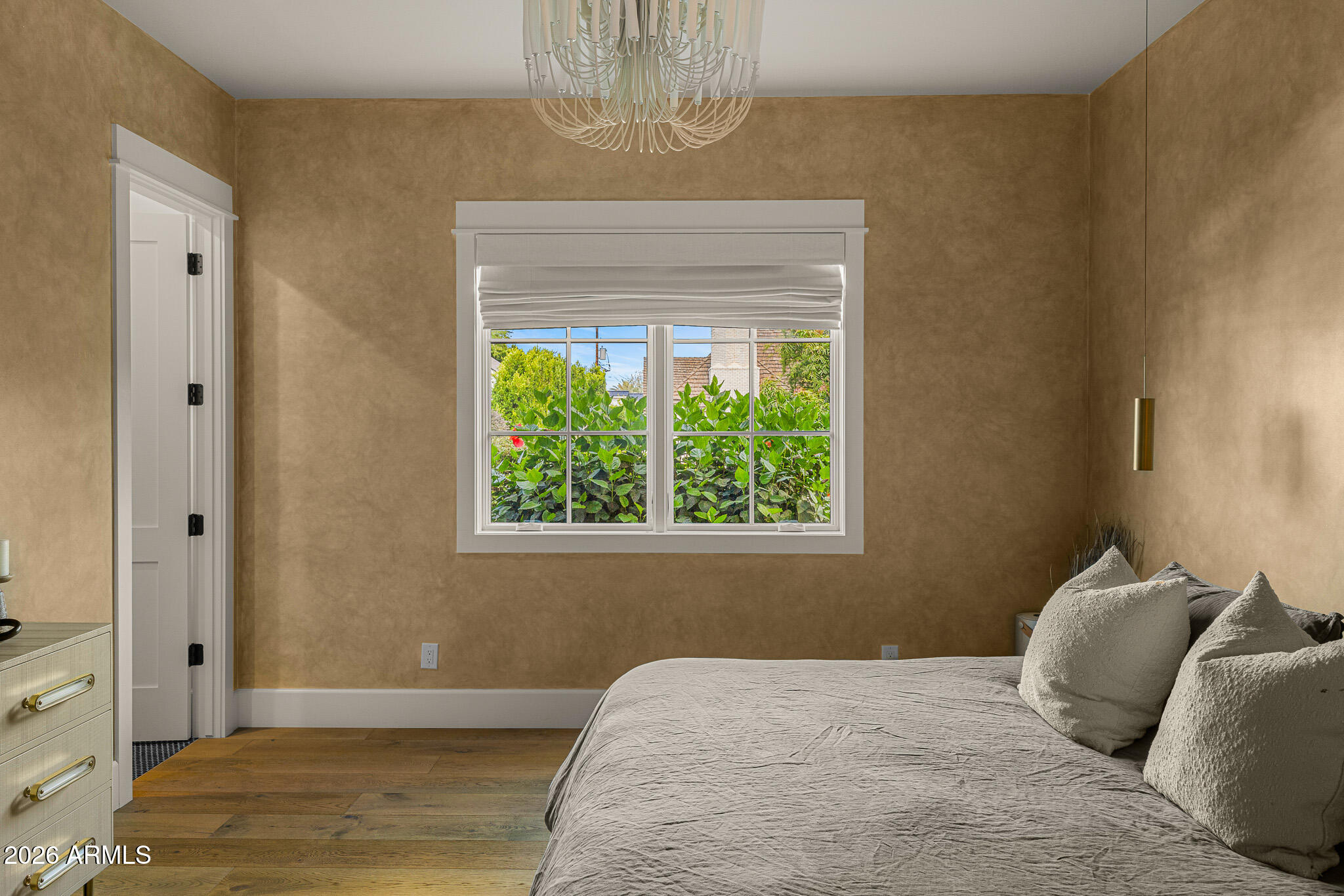 4204 North 57th Way Phoenix, AZ 85018 - Photo 21 of 34 a bedroom with a bed and a window