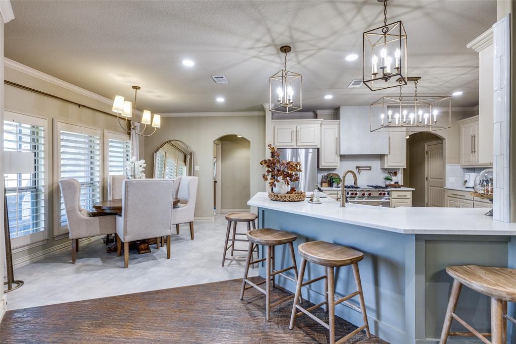 1150 Lone Star Road Bowie, TX 76230 - Photo 18 of 35 a view of a dining room with furniture a chandelier and wooden floor