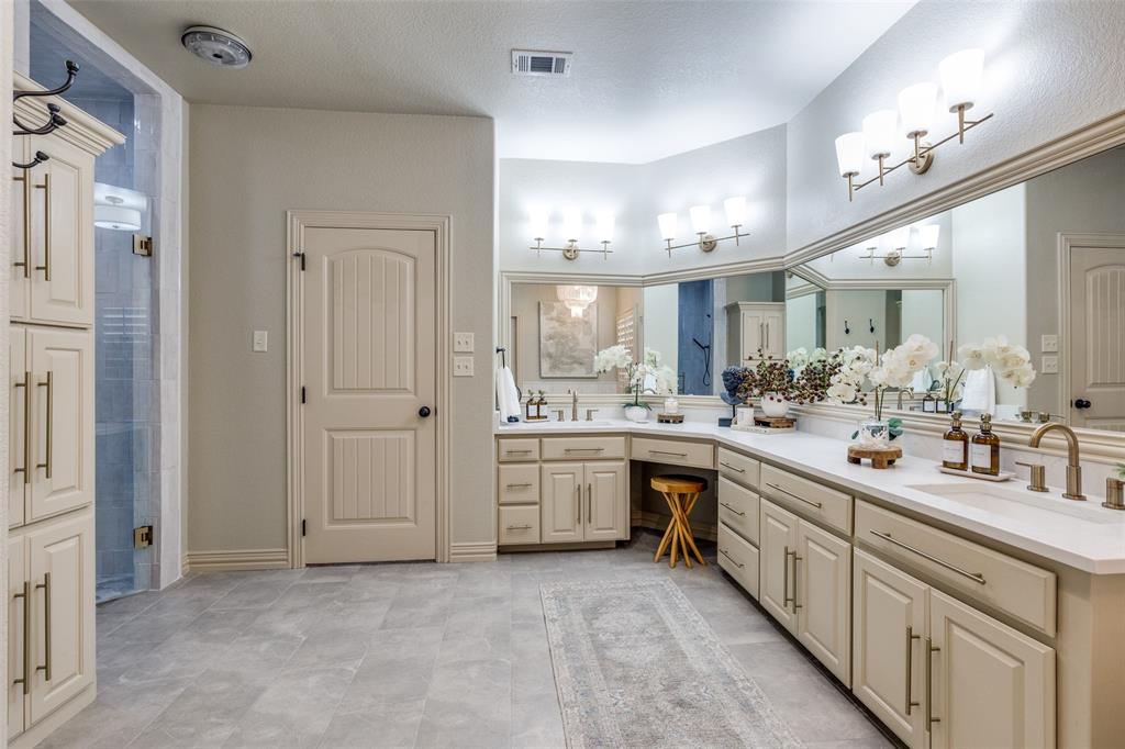 1150 Lone Star Road Bowie, TX 76230 - Photo 23 of 35 a large bathroom with a double vanity sink a mirror and a shower