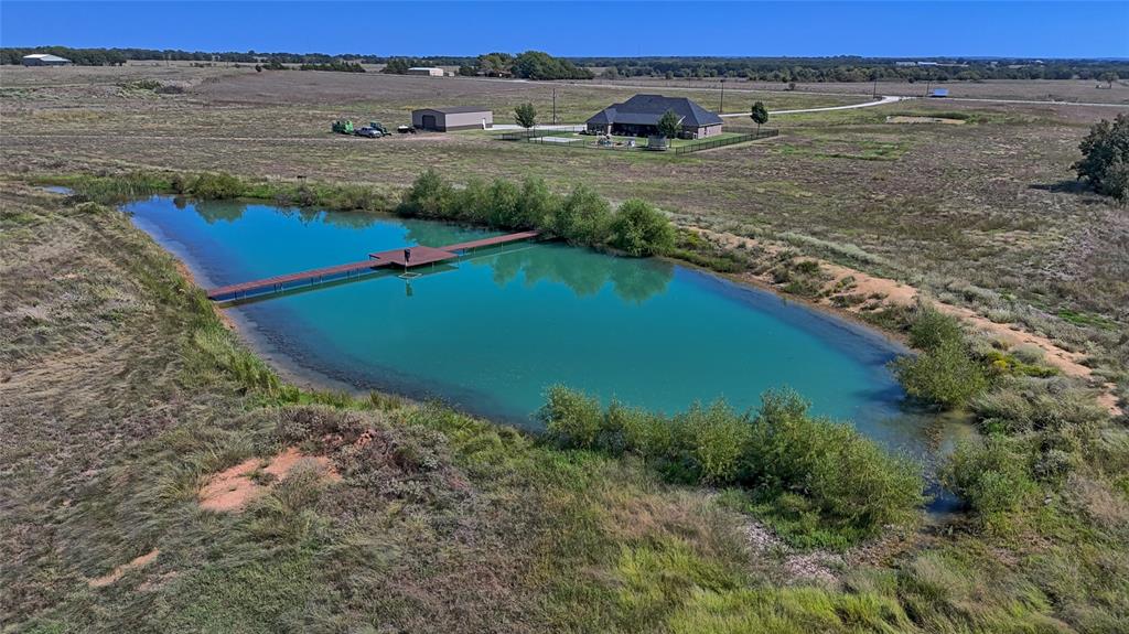 1150 Lone Star Road Bowie, TX 76230 - Photo 31 of 35 a view of a lake with a yard