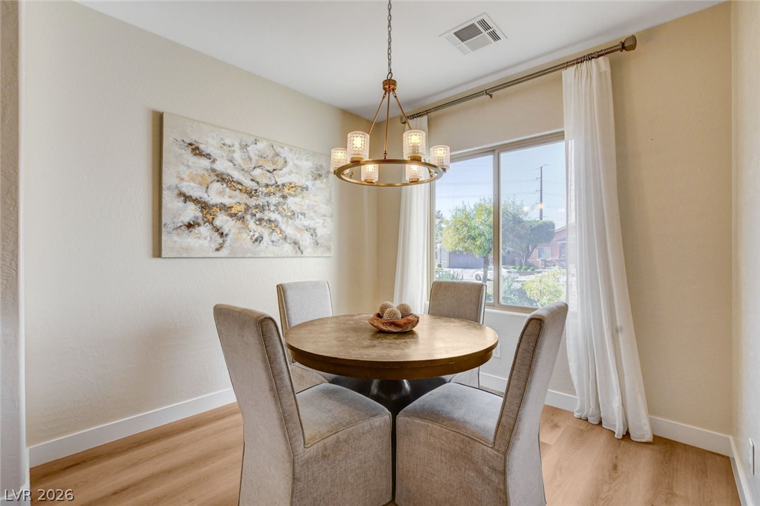 2649 Rue Marquette Avenue Henderson, NV 89044 - Photo 25 of 55 This intimate dining area is thoughtfully arranged for comfortable meals, featuring natural light and practical wood flooring.