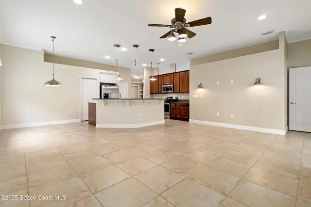 a view of a kitchen with a refrigerator and a sink