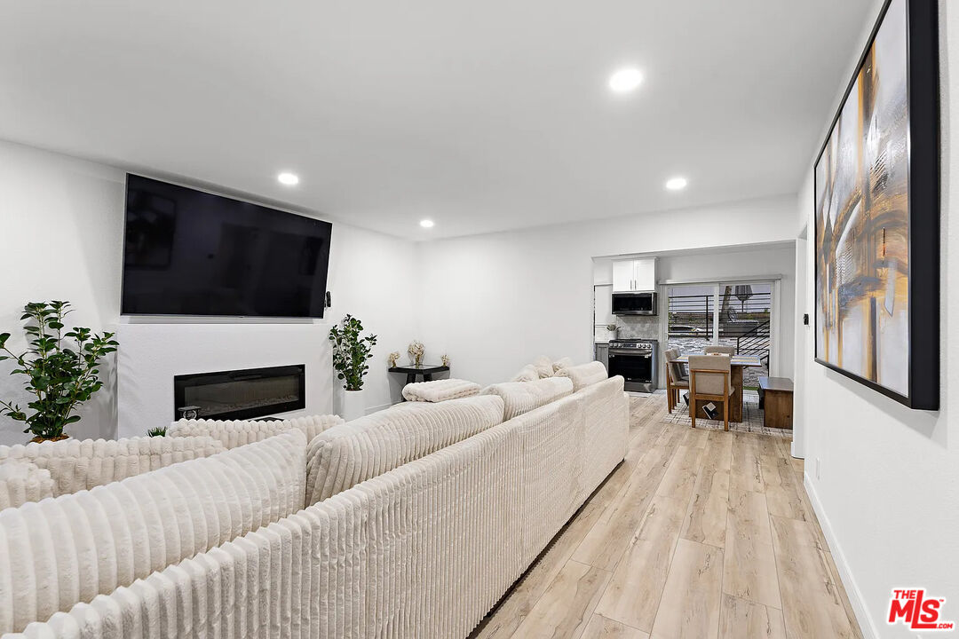8222 Pershing Drive Playa del Rey, CA 90293 - Photo 15 of 36 a living room with furniture a fireplace and a flat screen tv