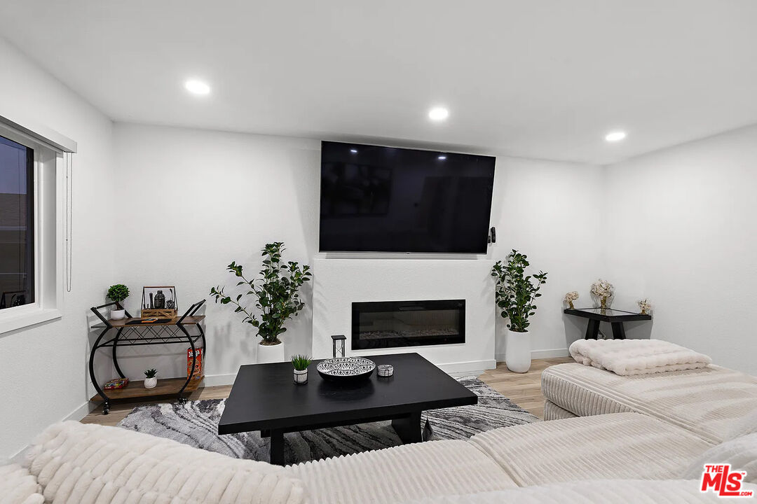 8222 Pershing Drive Playa del Rey, CA 90293 - Photo 16 of 36 a living room with furniture a fireplace and a flat screen tv