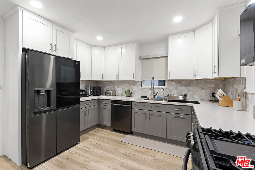 8222 Pershing Drive Playa del Rey, CA 90293 - Photo 20 of 36 a kitchen with a refrigerator and a stove top oven