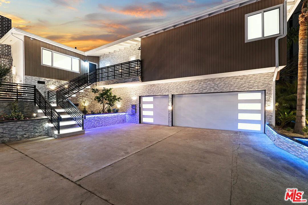 8222 Pershing Drive Playa del Rey, CA 90293 - Photo 2 of 36 a front view of a house with a yard and garage