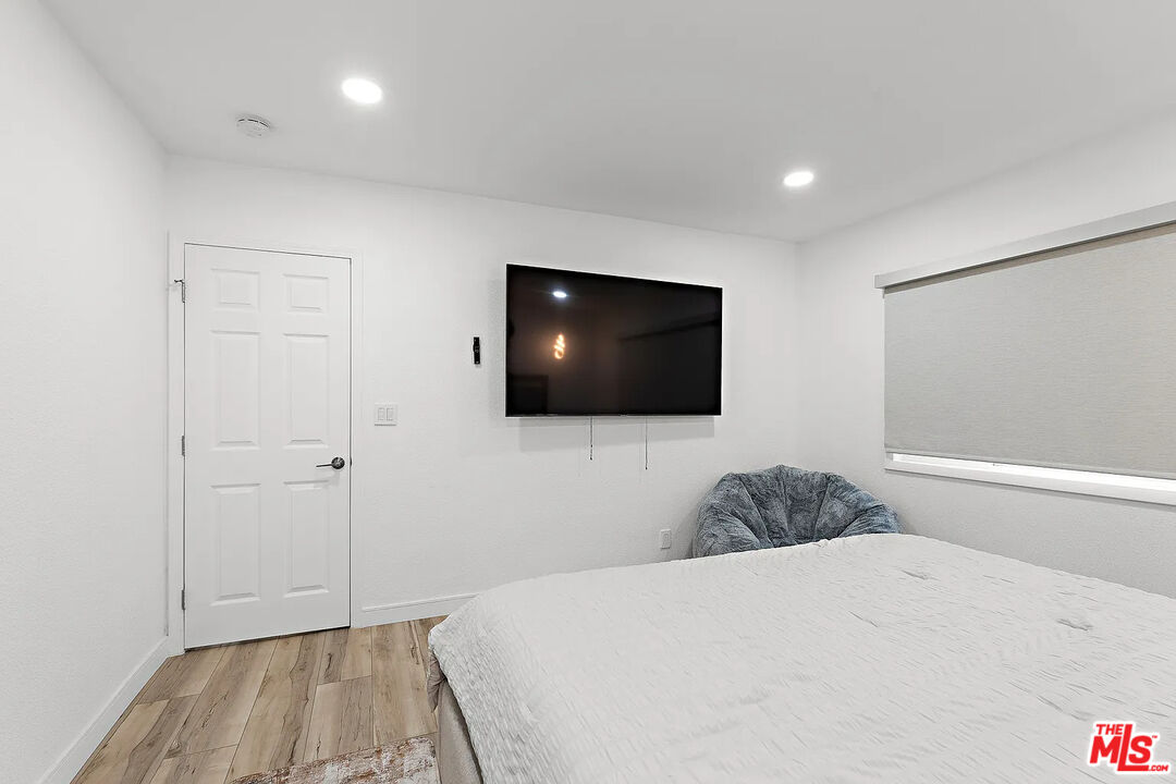 8222 Pershing Drive Playa del Rey, CA 90293 - Photo 24 of 36 a bedroom with a bed and a flat screen tv