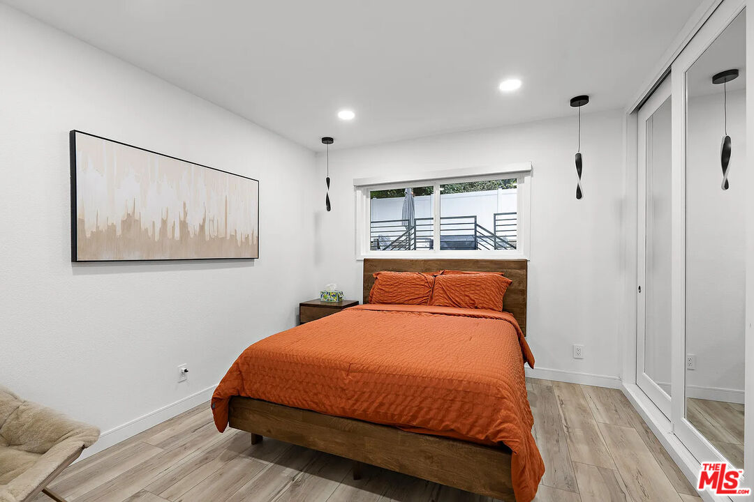 8222 Pershing Drive Playa del Rey, CA 90293 - Photo 28 of 36 a bedroom with a bed and wooden floor