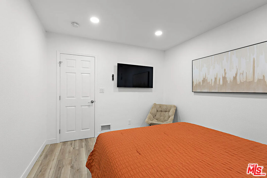 8222 Pershing Drive Playa del Rey, CA 90293 - Photo 29 of 36 a bedroom with a bed and a flat screen tv