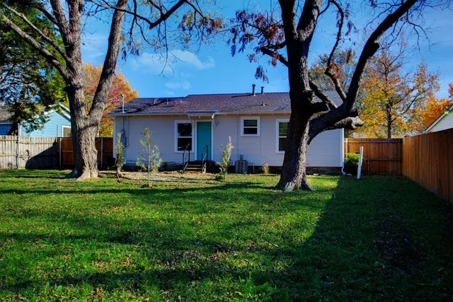 a backyard of a house with table and chairs