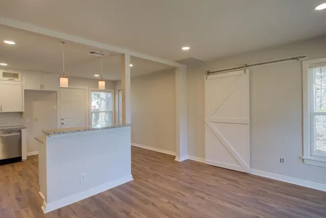 a view of kitchen with wooden floor and electronic appliances