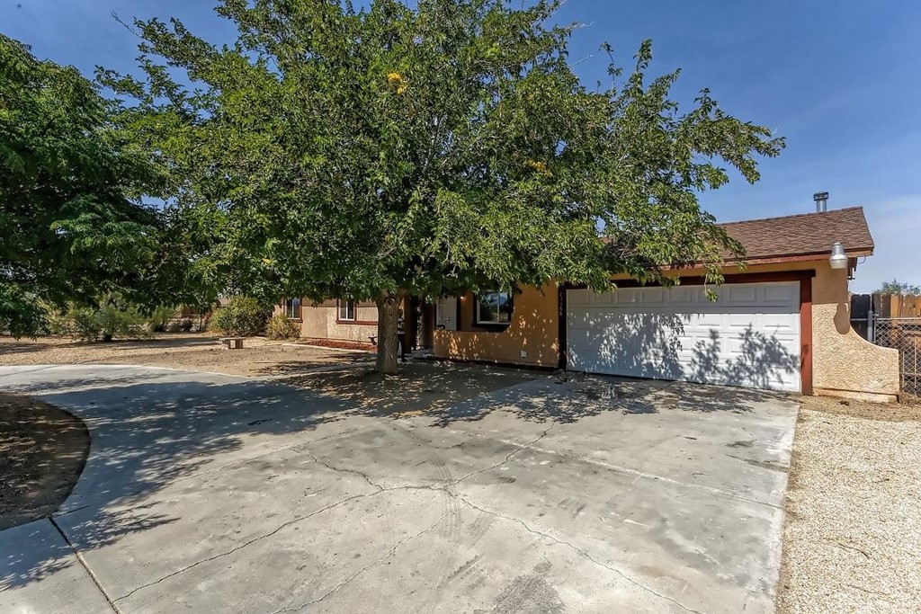 21168 Tussing Ranch Road Apple Valley, CA 92308 - Photo 1 of 1 a view of a yard with a tree