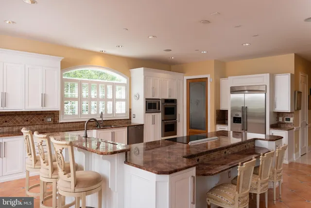 a kitchen with stainless steel appliances granite countertop a stove and a sink