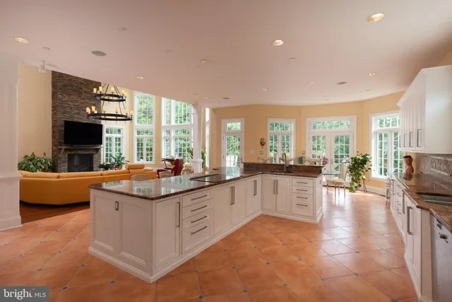 a kitchen with stainless steel appliances granite countertop a refrigerator and a stove