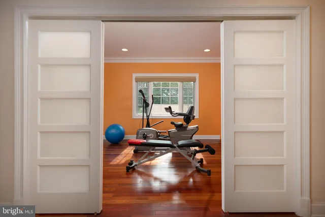 a large white bathroom with a large mirror vanity and a sink