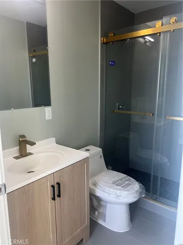 a white toilet sitting next to a bathroom sink