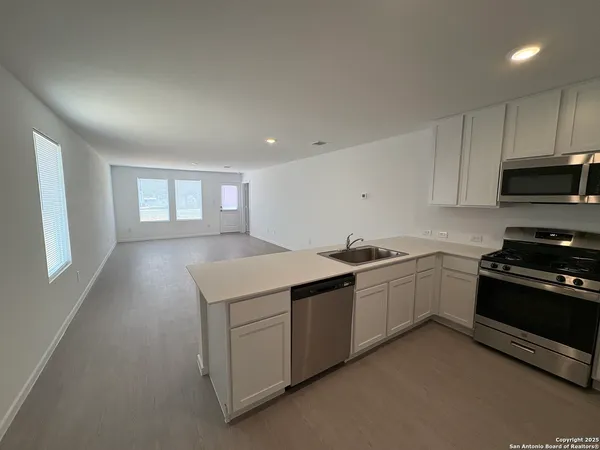 a kitchen that has a sink and a stove in it