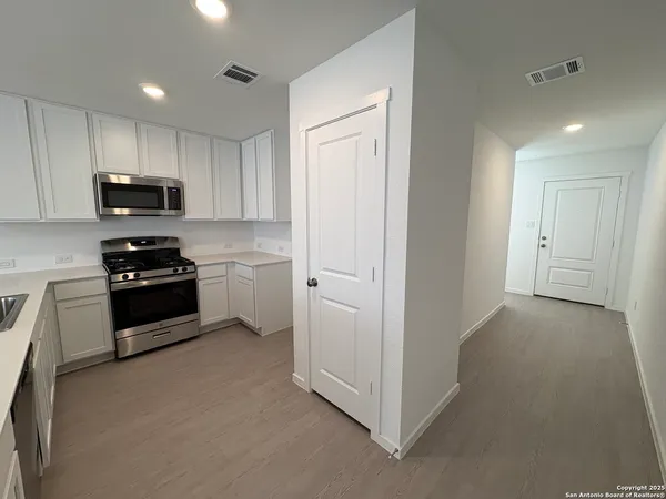 a kitchen with stainless steel appliances a refrigerator a stove top oven a sink and dishwasher