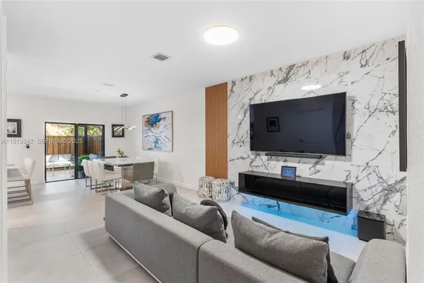 a living room with furniture and a flat screen tv