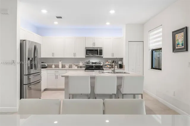a kitchen with a sink stove and refrigerator