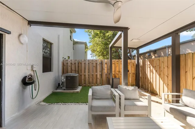 a backyard of a house with table and chairs