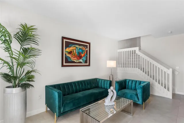 a living room with furniture and a potted plant