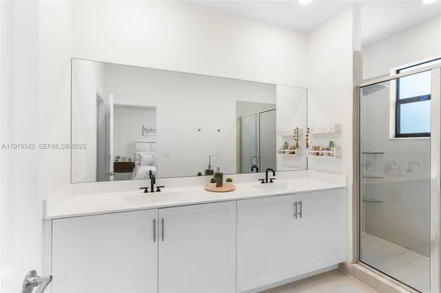 a bathroom with double sink and a mirror