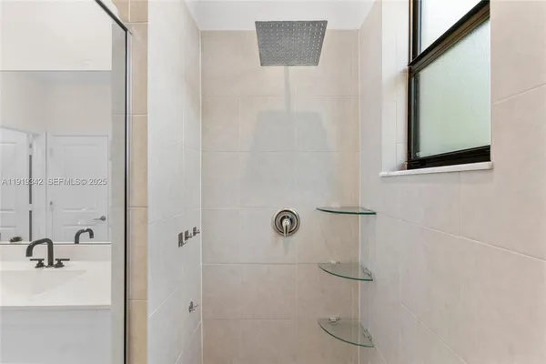 a view of walk in closet with clothes