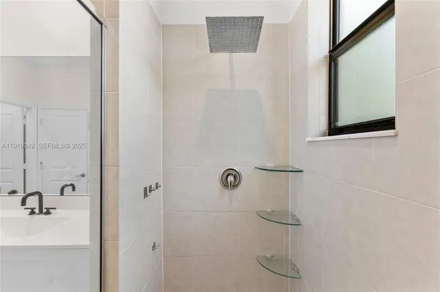 a view of walk in closet with clothes