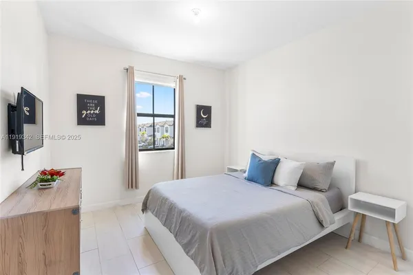 a hotel room with a bed and a flat screen tv