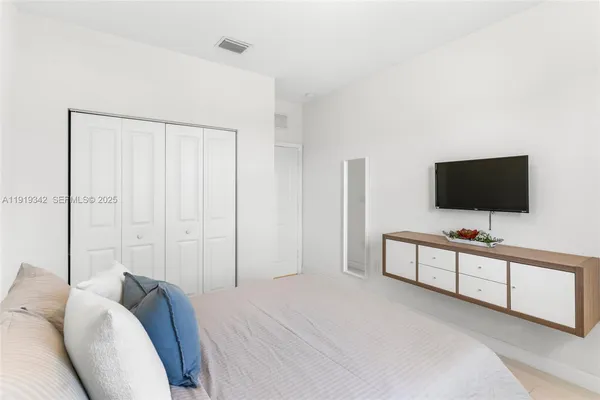 a bathroom with a granite countertop sink a toilet and a mirror