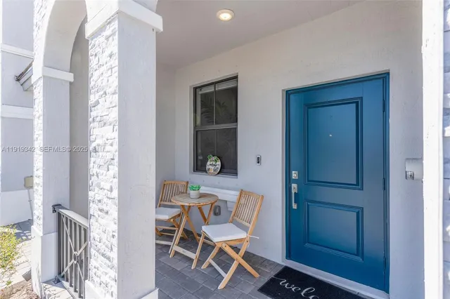 a living room with furniture flowerpot and wooden floor