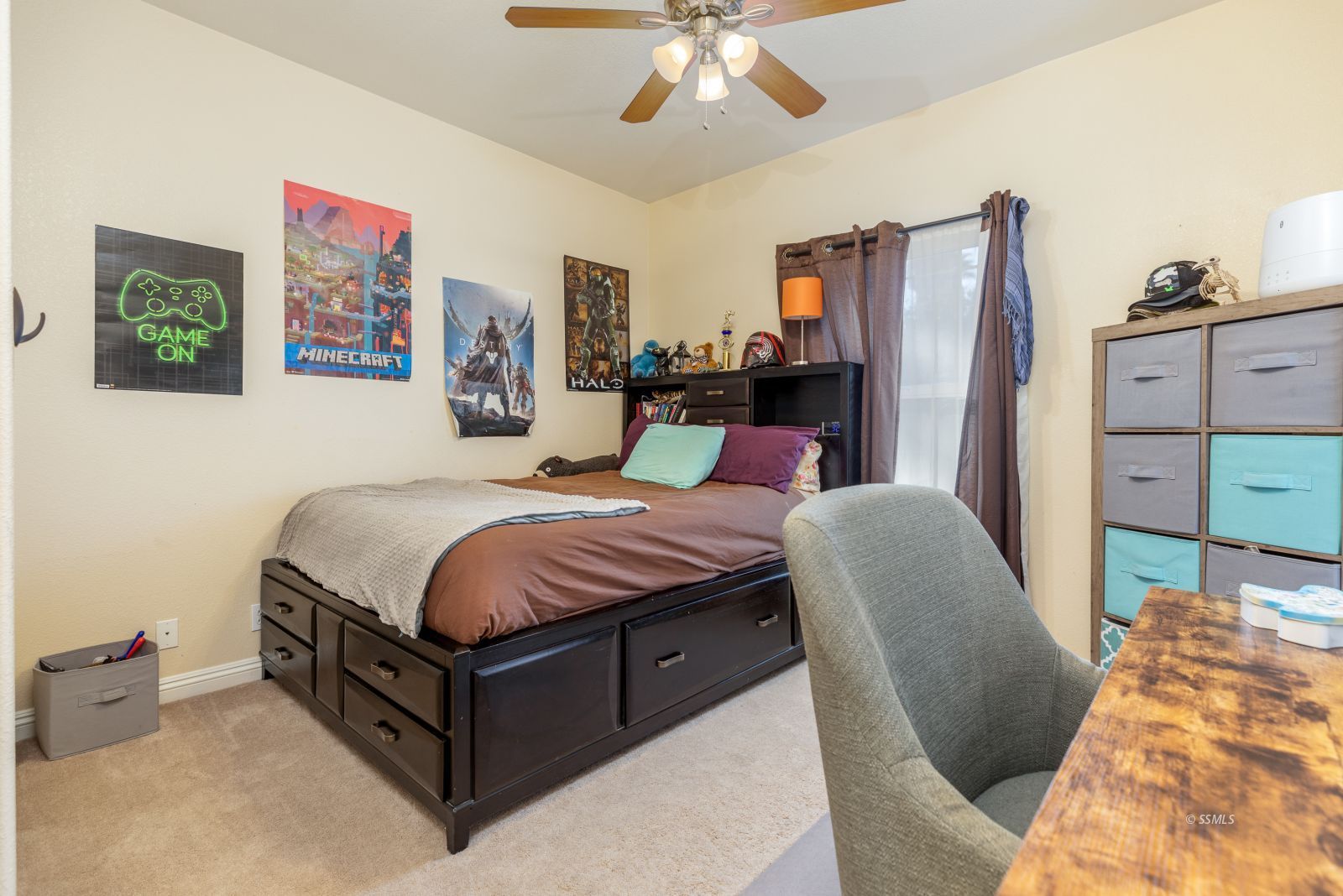 1219 Carolyn Street Ridgecrest, CA 93555 - Photo 25 of 47 a bed room with a bed and a chandelier