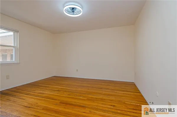 an empty room with wooden floor