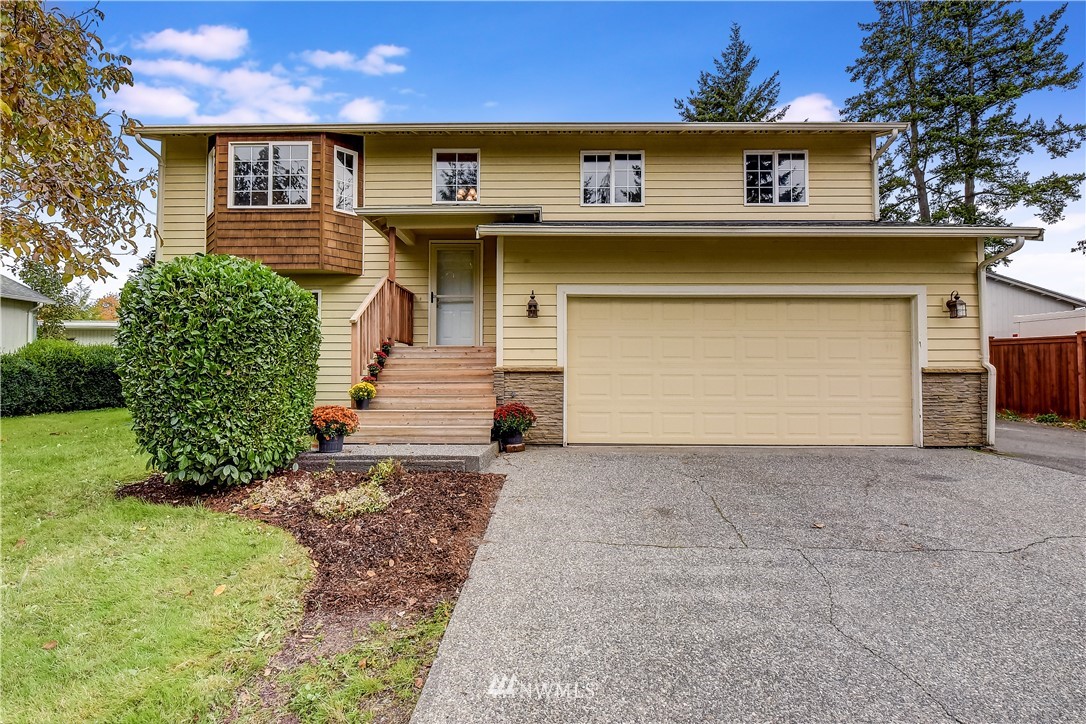 2319 Cherry Road Lake Stevens, WA 98258 - Photo 1 of 25 a front view of a house with a yard and garage